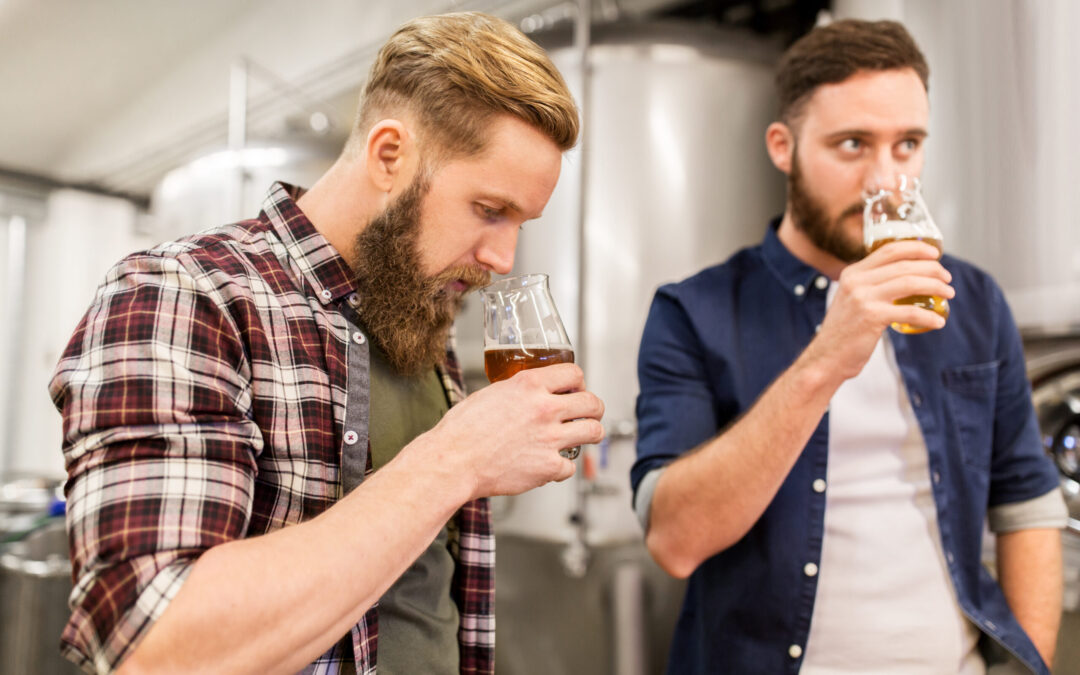 men drinking and testing craft beer at brewery